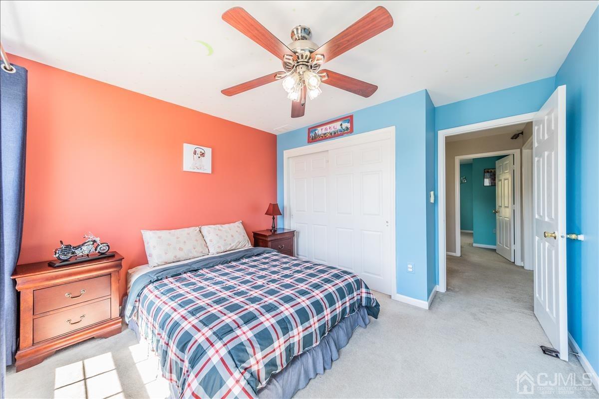 46 Potomac Road Monmouth Junction, NJ 08852 - Photo 31 of 42 a bedroom with a bed and a chandelier