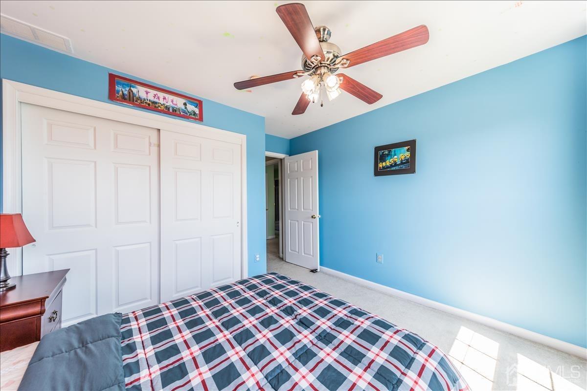 46 Potomac Road Monmouth Junction, NJ 08852 - Photo 32 of 42 a bedroom with a bed and a chandelier