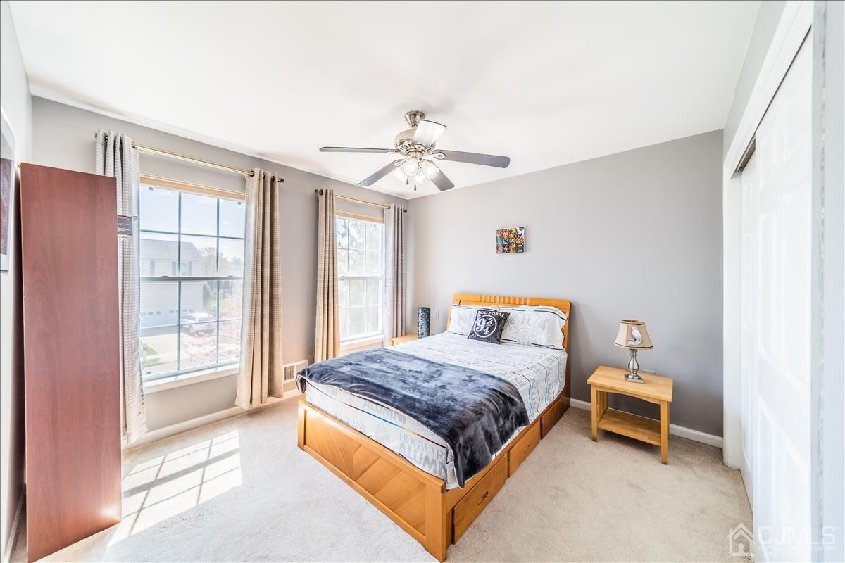 46 Potomac Road Monmouth Junction, NJ 08852 - Photo 35 of 42 a bedroom with a bed and a chandelier