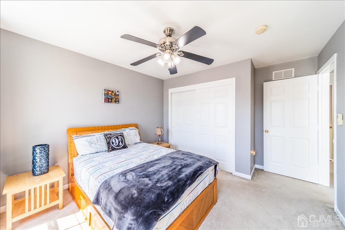 46 Potomac Road Monmouth Junction, NJ 08852 - Photo 36 of 42 a bedroom with a bed and a chandelier