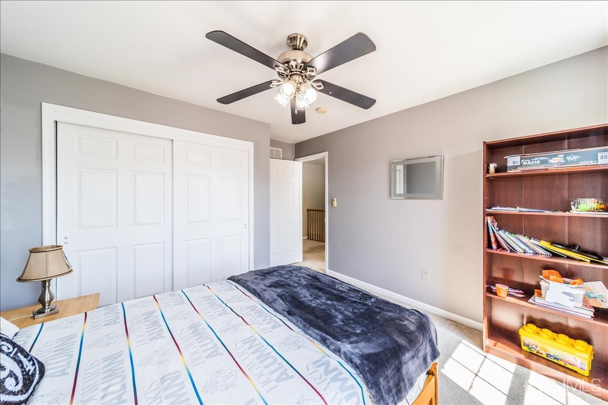 46 Potomac Road Monmouth Junction, NJ 08852 - Photo 37 of 42 a bedroom with a bed and a chandelier
