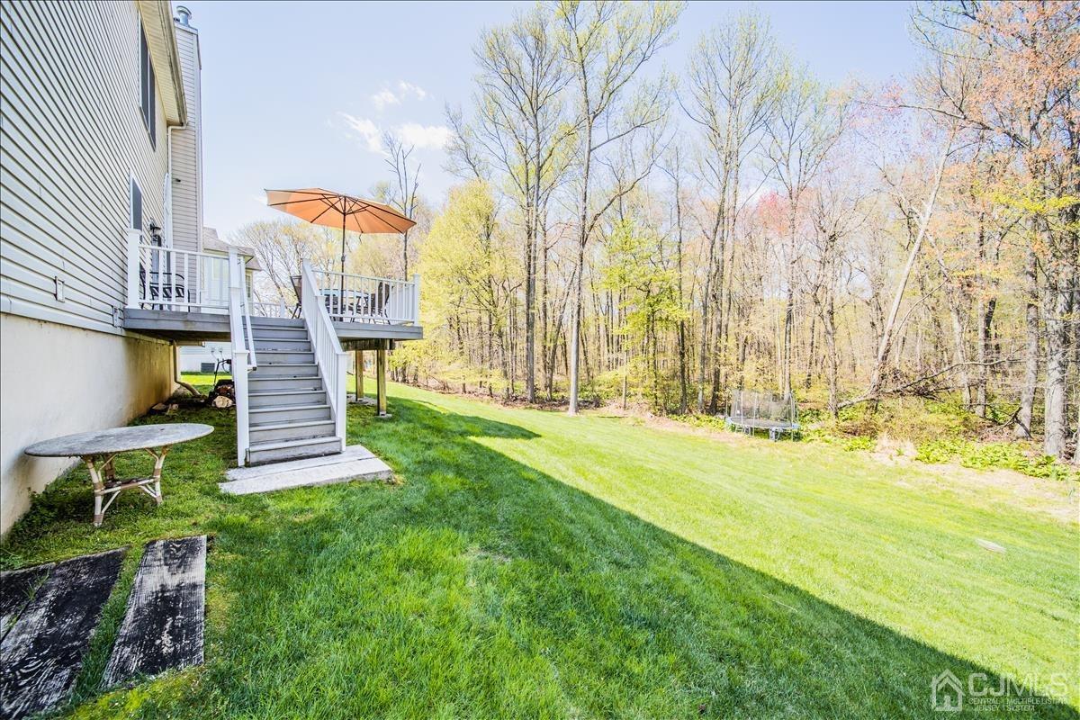 46 Potomac Road Monmouth Junction, NJ 08852 - Photo 42 of 42 a view of a backyard with table and chairs and wooden fence