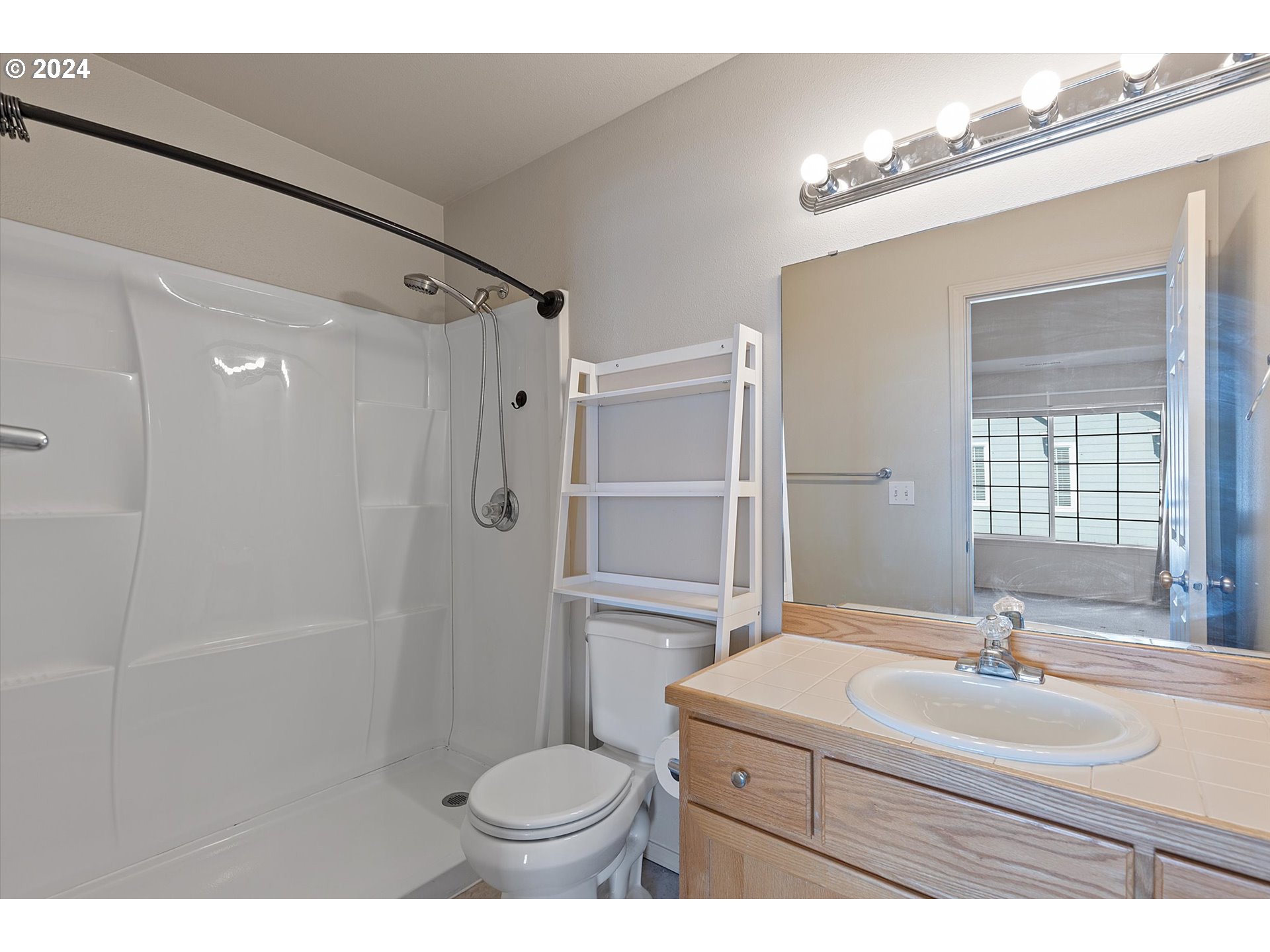 3181 Southwest 177th Place Beaverton, OR 97003 - Photo 19 of 31 a bathroom with a sink toilet a mirror and shower