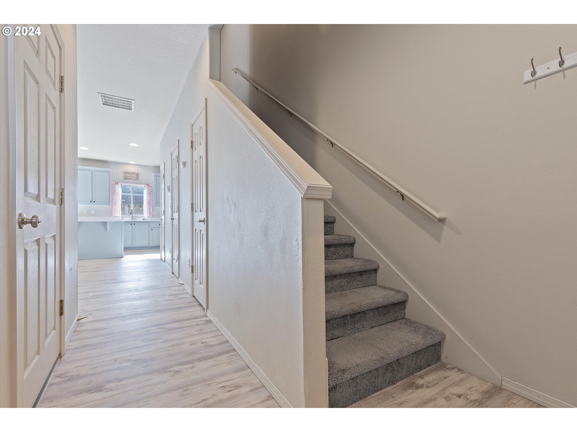 3181 Southwest 177th Place Beaverton, OR 97003 - Photo 4 of 31 a view of a hallway with wooden floor and staircase