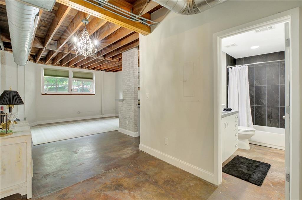 172 Carroll Street Southeast, Unit 103 Atlanta, GA 30312 - Photo 12 of 23 a bathroom with a tub shower and sink