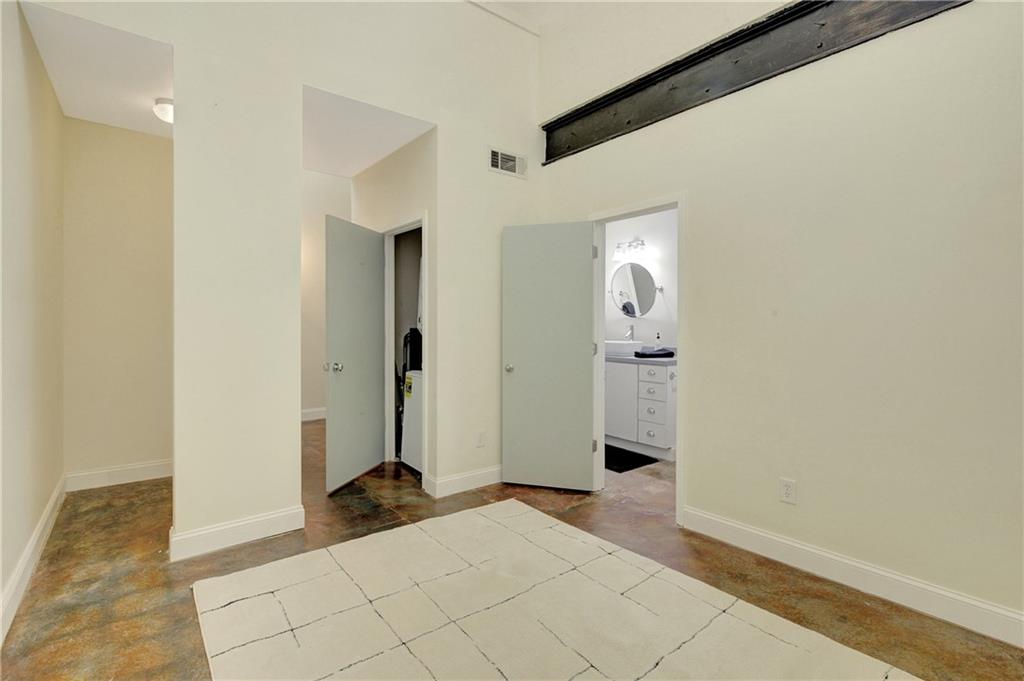 172 Carroll Street Southeast, Unit 103 Atlanta, GA 30312 - Photo 15 of 23 a view of a hallway with wooden floor and a bathroom