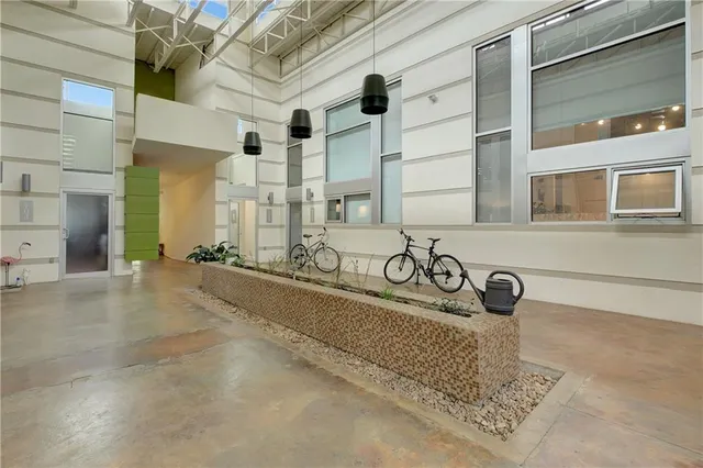 a view of a hallway with wooden floor and furniture