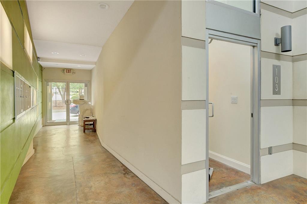 172 Carroll Street Southeast, Unit 103 Atlanta, GA 30312 - Photo 21 of 23 a view of a hallway with wooden floor and furniture