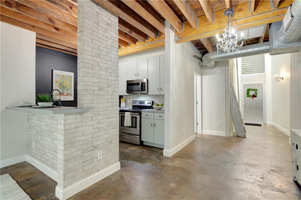 172 Carroll Street Southeast, Unit 103 Atlanta, GA 30312 - Photo 7 of 23 a view of a refrigerator and an empty room