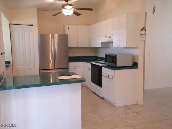a kitchen with stainless steel appliances granite countertop a refrigerator a stove a sink and a refrigerator