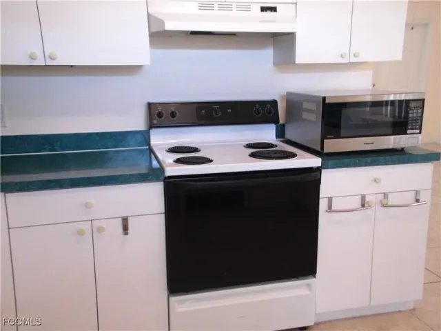 a kitchen with a stove and a microwave