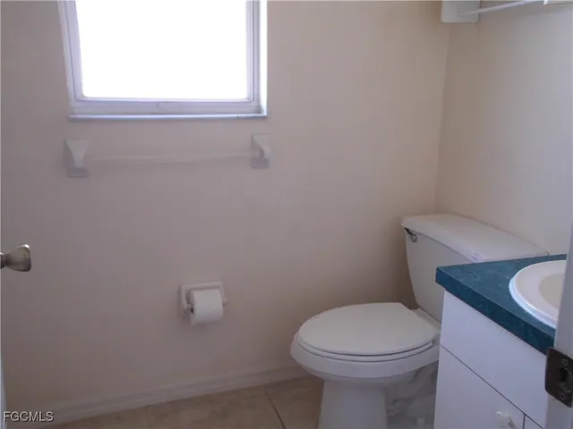 a white toilet sitting next to a bathroom sink