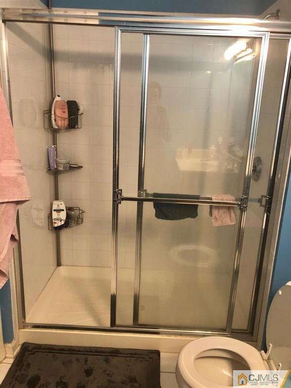 368 Rector Street, Unit 404 Perth Amboy, NJ 08861 - Photo 2 of 11 a bathroom with a shower and a toilet