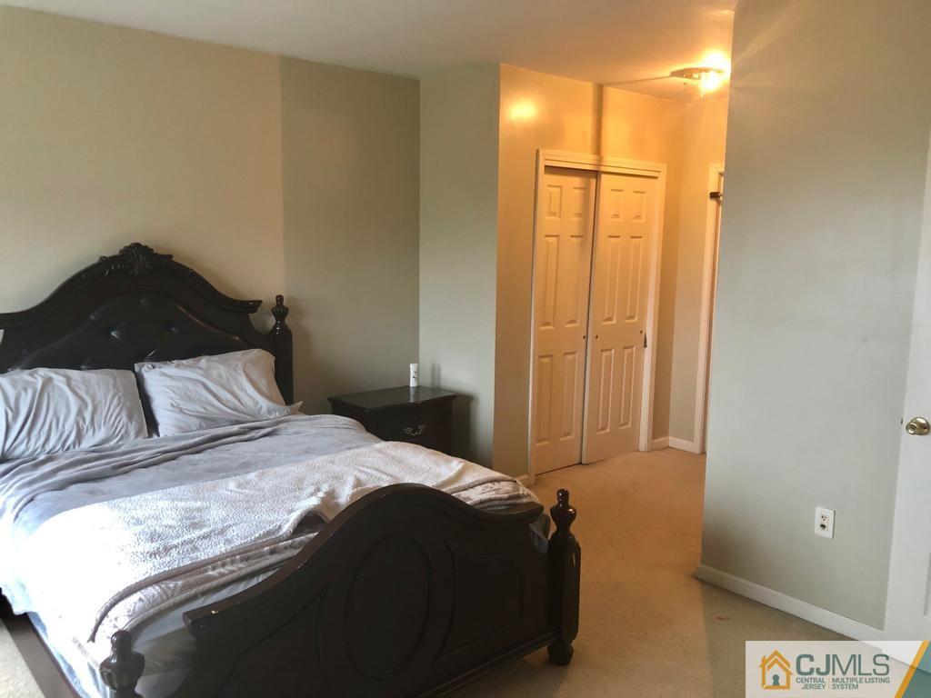 368 Rector Street, Unit 404 Perth Amboy, NJ 08861 - Photo 3 of 11 a bedroom with a bed and a dresser
