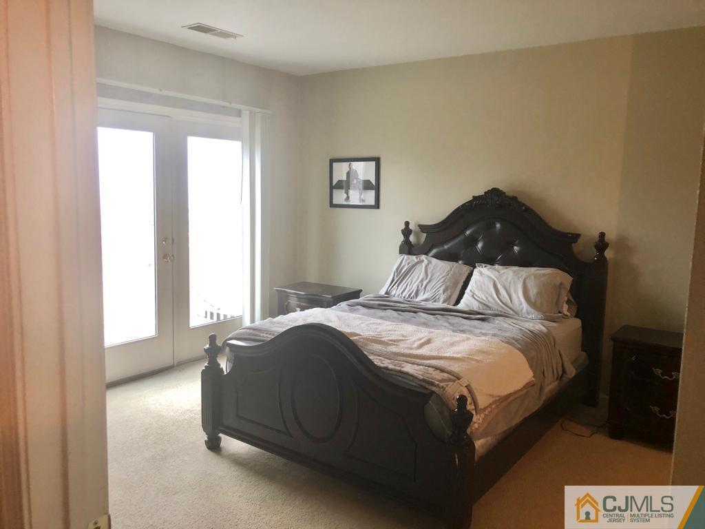368 Rector Street, Unit 404 Perth Amboy, NJ 08861 - Photo 5 of 11 a bedroom with a bed and window