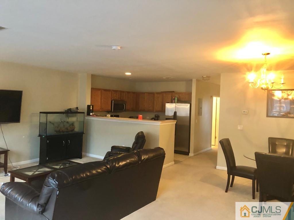 368 Rector Street, Unit 404 Perth Amboy, NJ 08861 - Photo 8 of 11 a living room with furniture and a flat screen tv
