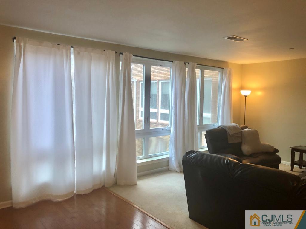 368 Rector Street, Unit 404 Perth Amboy, NJ 08861 - Photo 10 of 11 a living room with furniture and a window