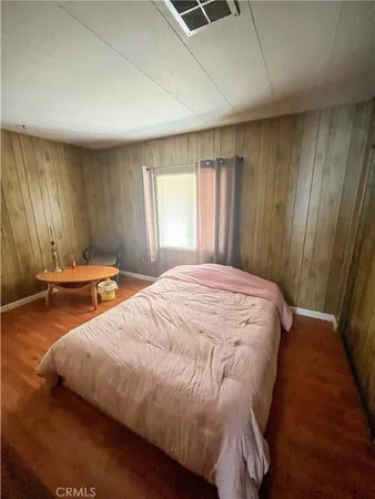 a bed sitting in a room next to a window