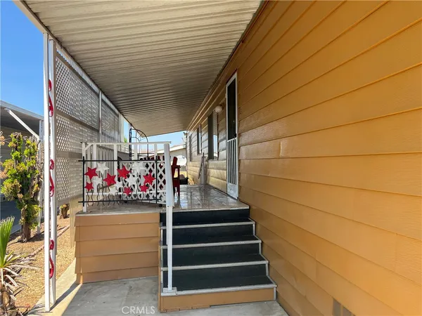 a view of a garage with an outdoor seating