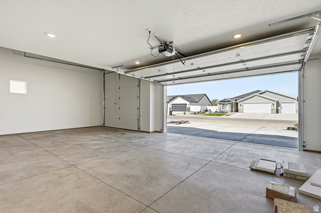 4978 North 75 East Enoch, UT 84721 - Photo 33 of 60 Garage with a residential view, a garage door opener, and recessed lighting