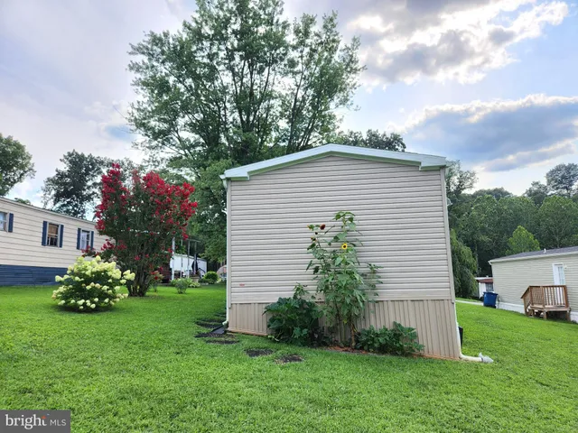 a view of a house with a yard porch and sitting area