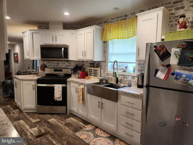 a kitchen with a sink stove and microwave