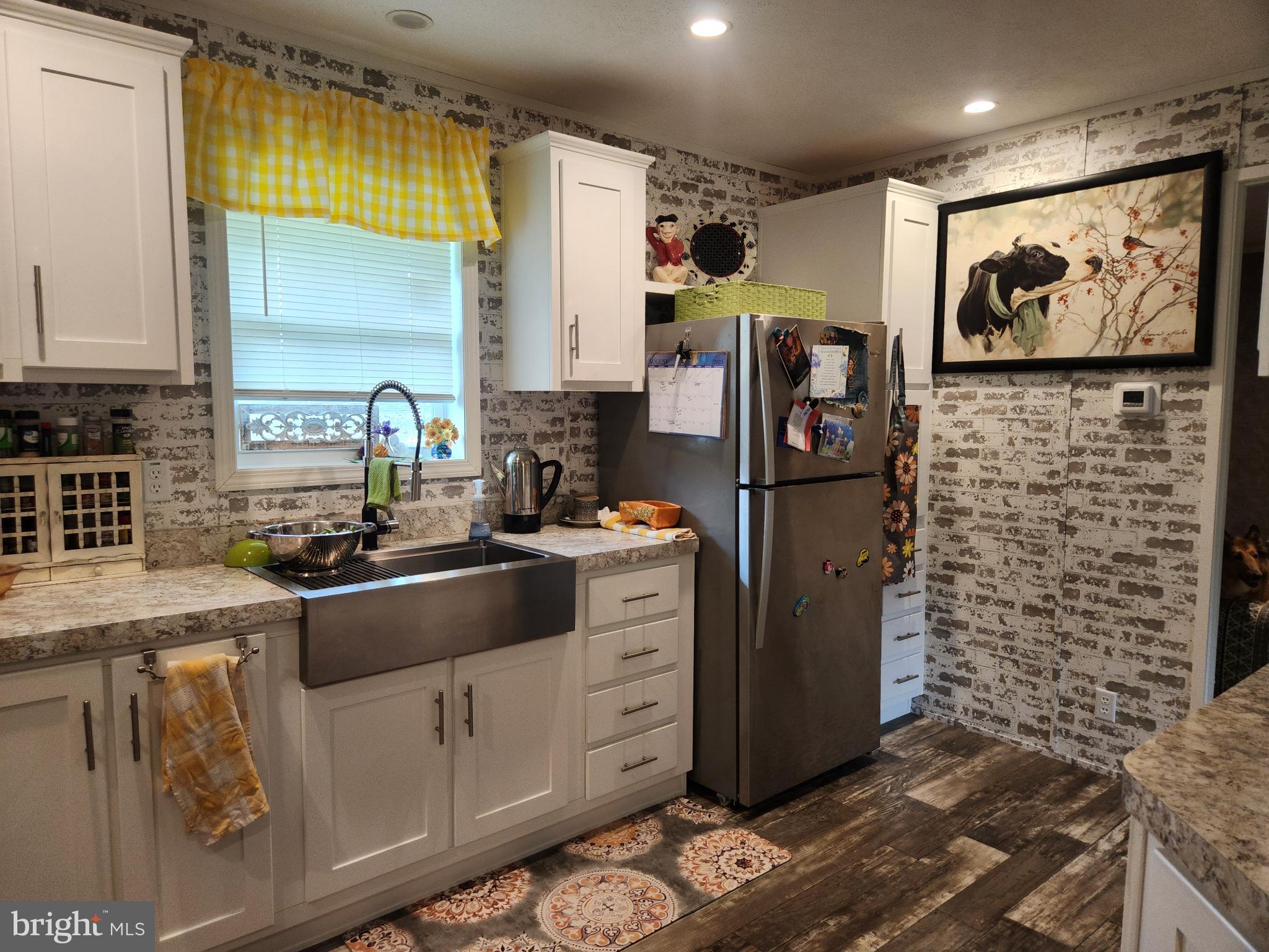 16 Mill Street York, PA 17406 - Photo 9 of 29 a kitchen with stainless steel appliances granite countertop a refrigerator sink and wooden cabinets