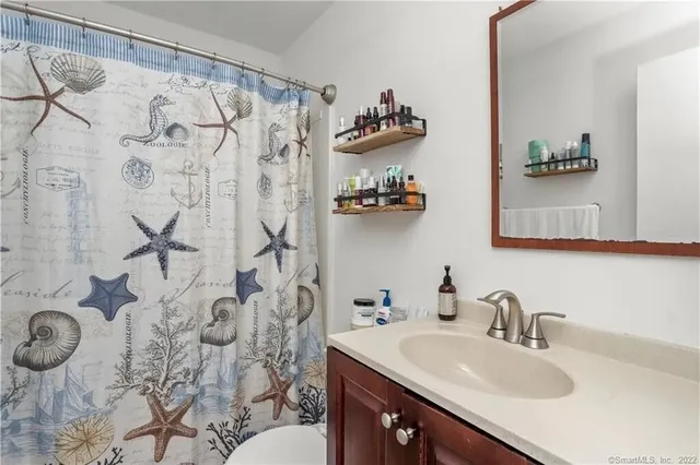 a bathroom with a sink toilet and shower