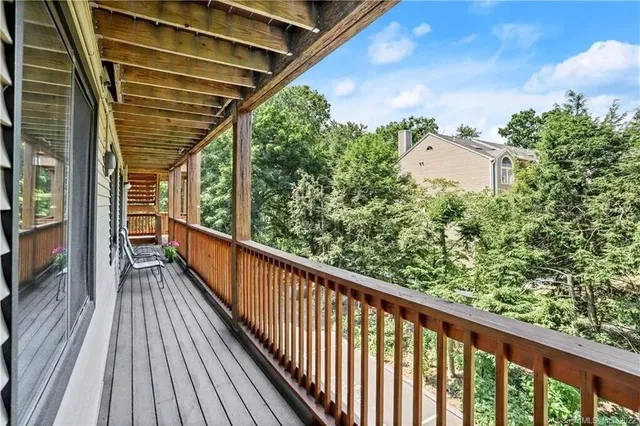 a view of balcony with wooden floor and fence