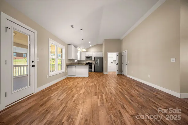 a view of a kitchen with a wooden floor and a window