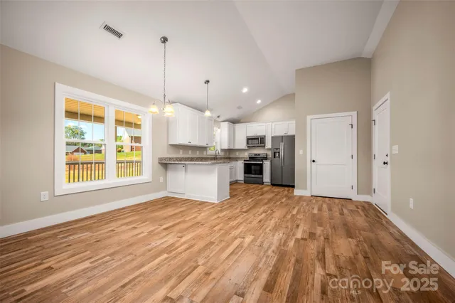 a kitchen with stainless steel appliances a refrigerator sink and microwave