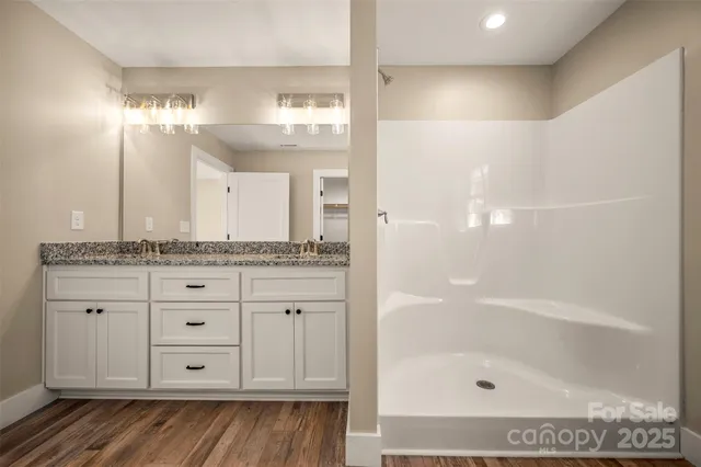 a view of a room with wooden floor