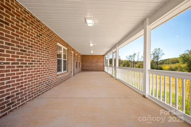 a view of a house with a yard and potted plants