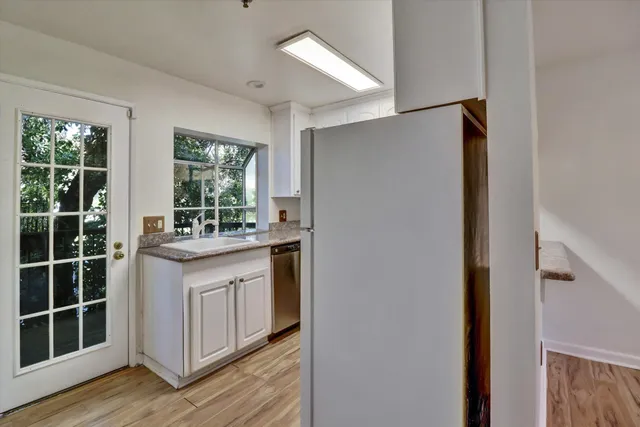 a kitchen with a stove a sink and a refrigerator