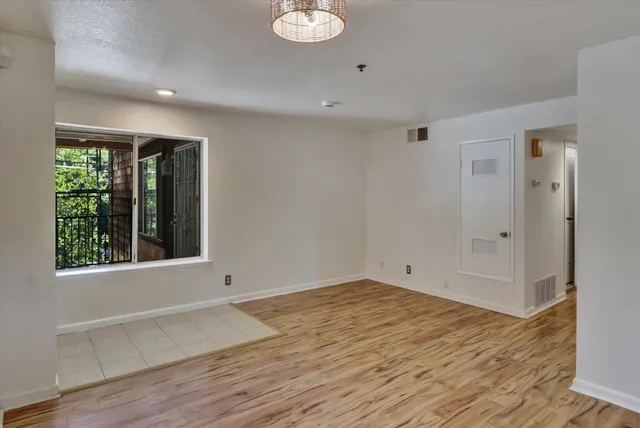 a view of a kitchen with wooden floor and a sink