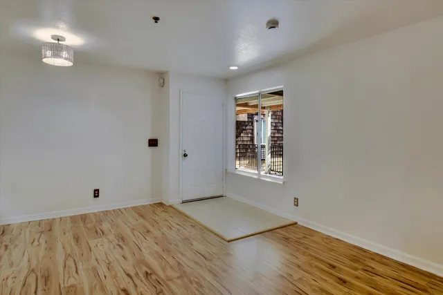 a living room with a large window and furniture
