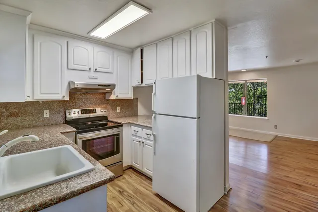 a kitchen with a refrigerator sink and stove