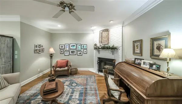 a bedroom with a bed a dresser and a chandelier