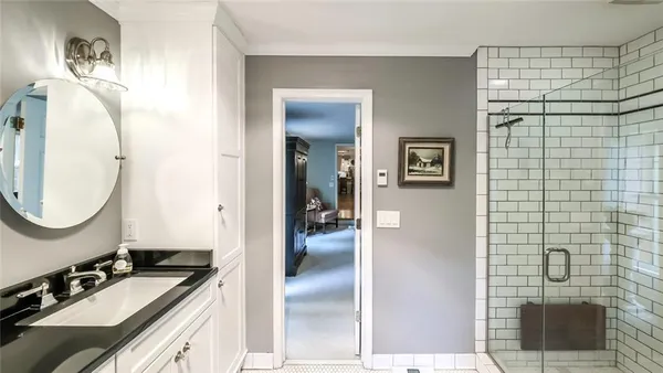 a en suite bathroom with a sink a mirror and shower