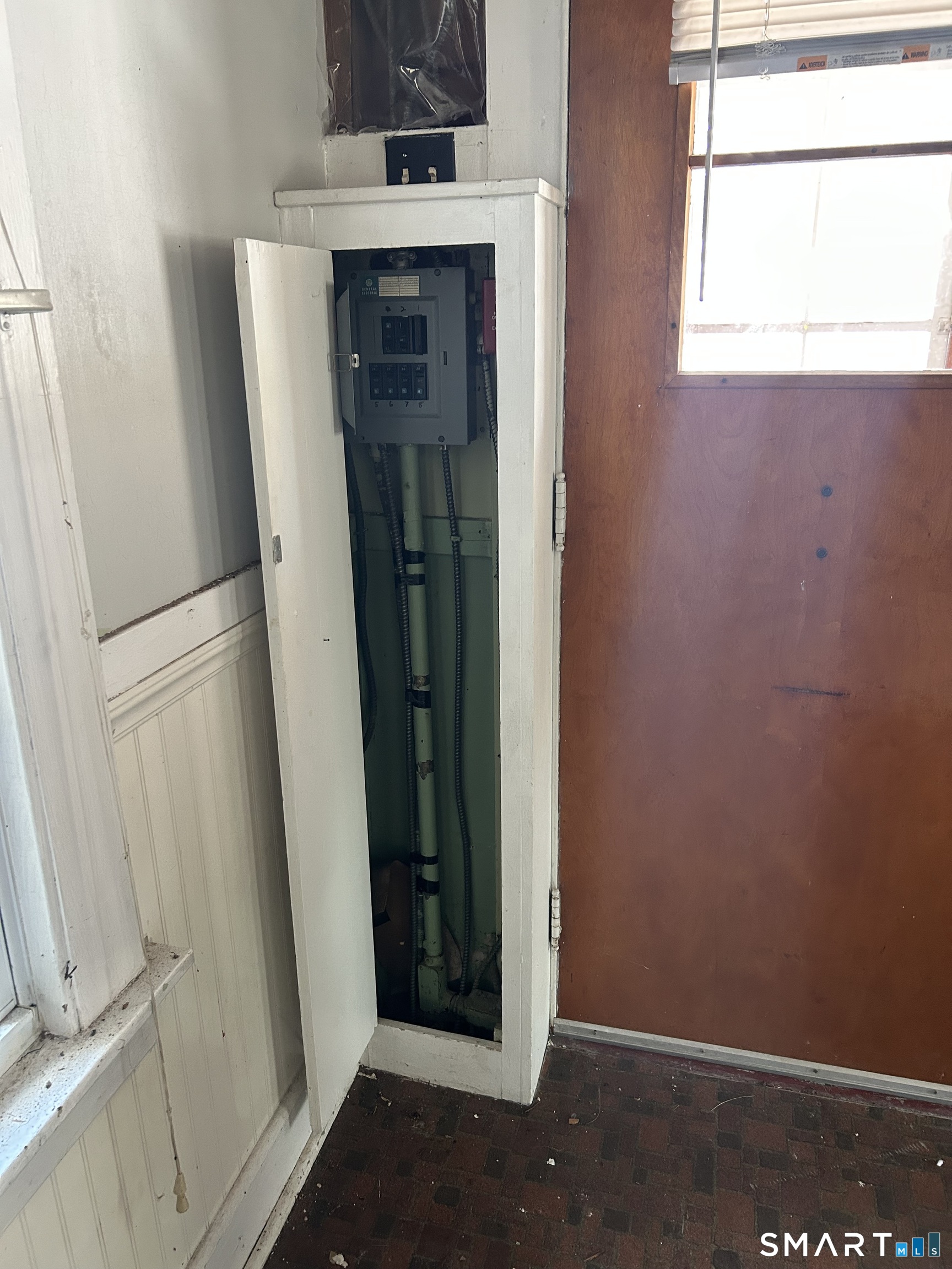 69 Munson Road Wolcott, CT 06716 - Photo 17 of 20 a view of storage and utility room with a fireplace