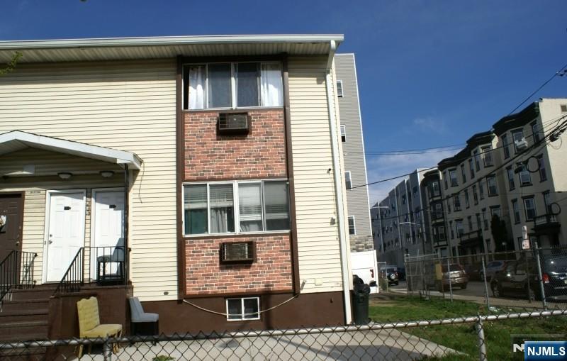 233 Straight Paterson, NJ 07501 - Photo 1 of 1 a front view of a house with a yard