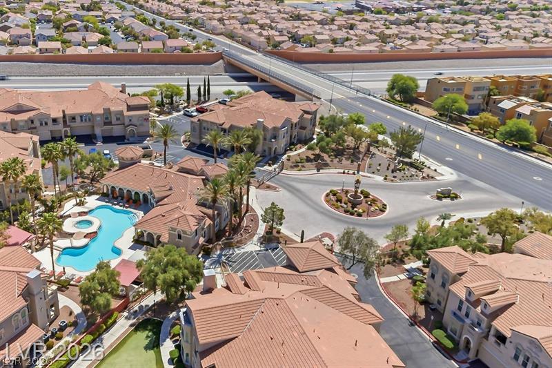 10550 West Alexander Road, Unit 2148 Las Vegas, NV 89129 - Photo 38 of 41 An aerial perspective reveals a vibrant community with inviting pool areas, lush landscaping, and seamless highway access.