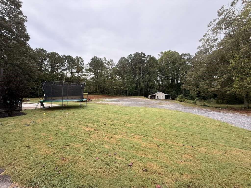 1463 Kellogg Creek Road Acworth, GA 30102 - Photo 15 of 55 a view of a swimming pool with a yard