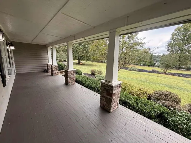 a view of house with backyard and trees