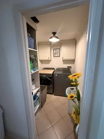 a living room with furniture fireplace and a large window