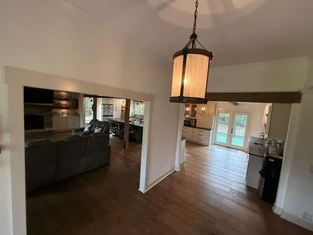 a kitchen with stainless steel appliances granite countertop a sink a stove and white cabinets