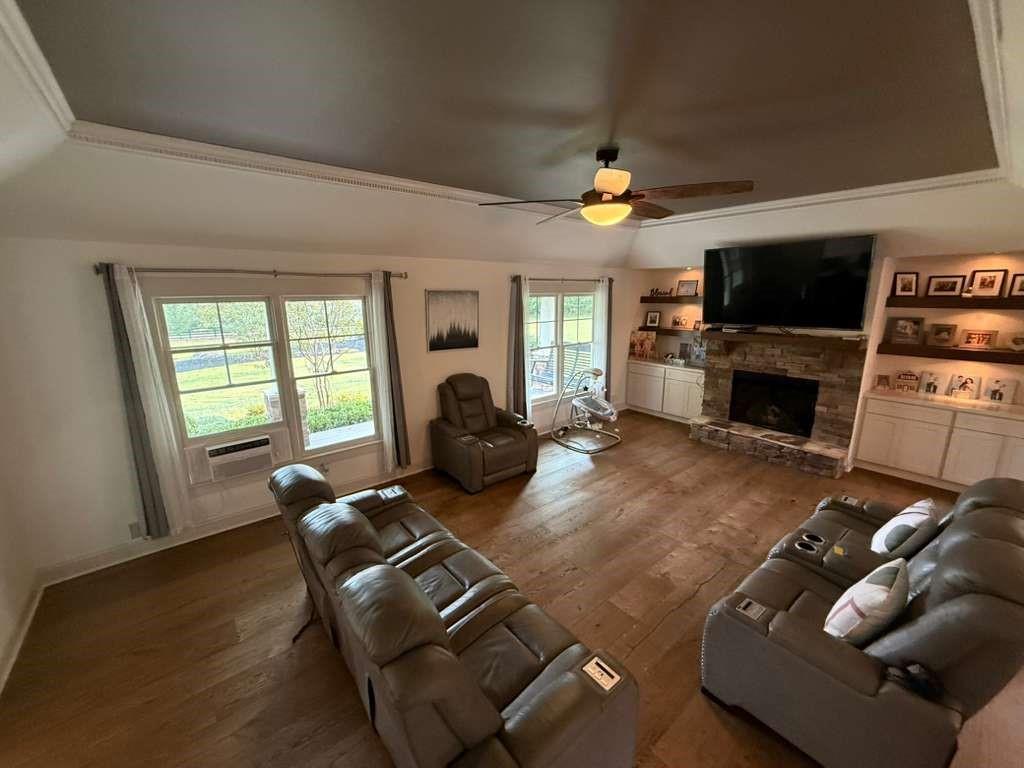 1463 Kellogg Creek Road Acworth, GA 30102 - Photo 34 of 55 a living room with furniture a flat screen tv and a fireplace