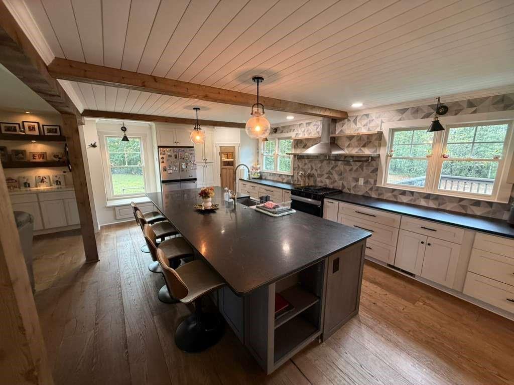 1463 Kellogg Creek Road Acworth, GA 30102 - Photo 36 of 55 a kitchen with stainless steel appliances a table chairs and a refrigerator