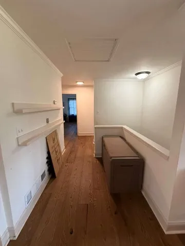 an empty room with closet and wooden floor