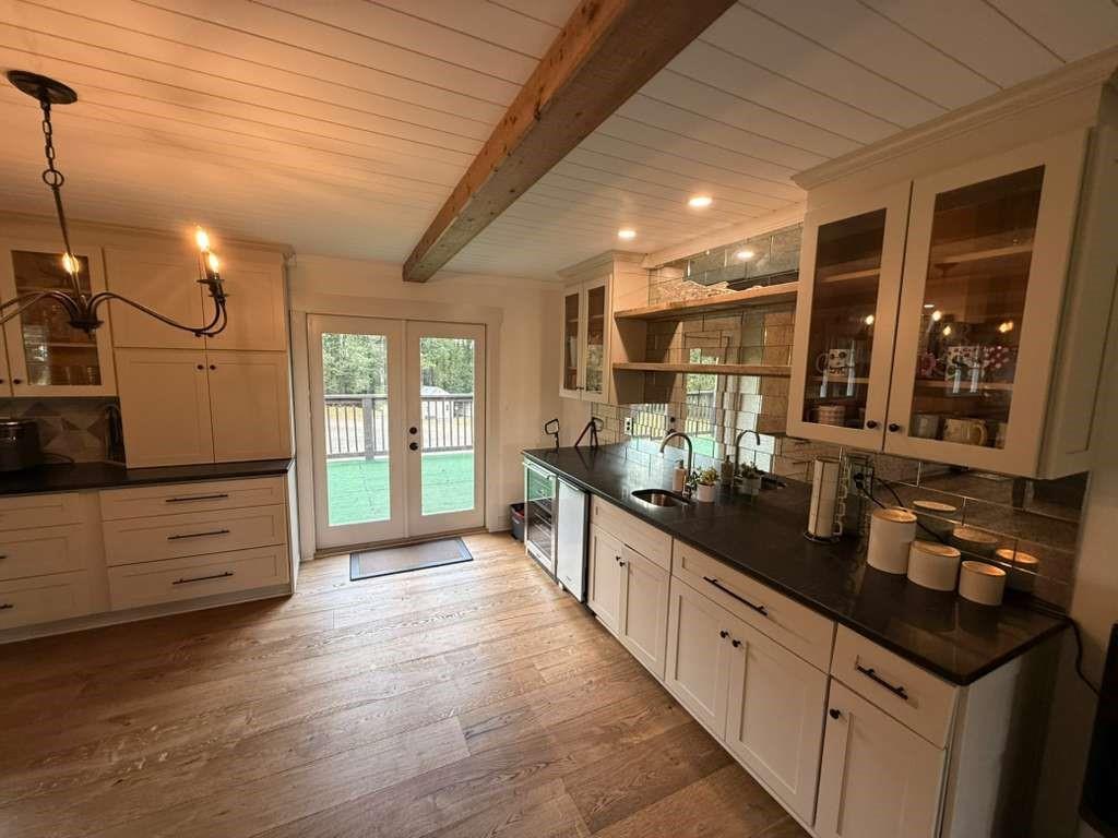 1463 Kellogg Creek Road Acworth, GA 30102 - Photo 43 of 55 a large kitchen with granite countertop a large counter top space a sink and stainless steel appliances